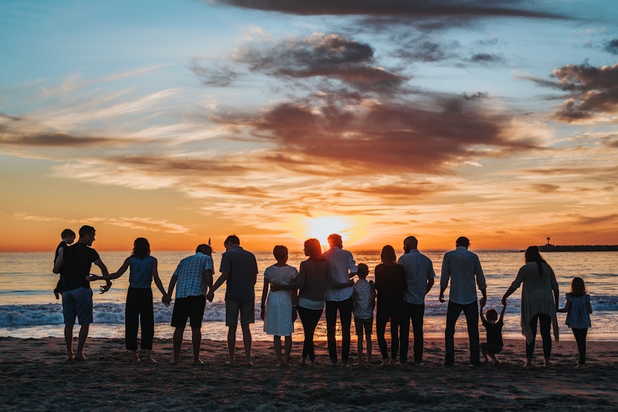 Three generations of a family holding hands at sunset